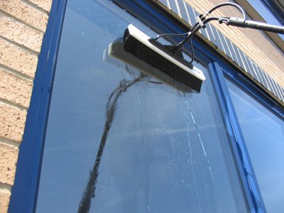 A water-fed pole cleaning a residential window